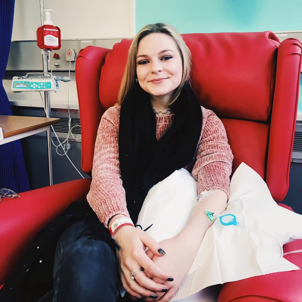 A person wearing a red leather chair

Description automatically generated